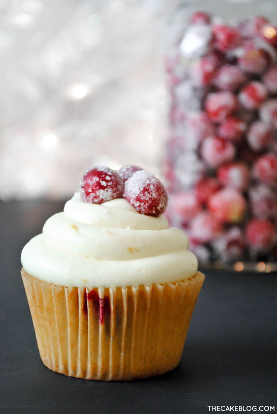 Cranberry Orange Cupcakes with sugared cranberries. Perfect for the holidays and Christmas dessert | Carrie Sellman for TheCakeBlog.com