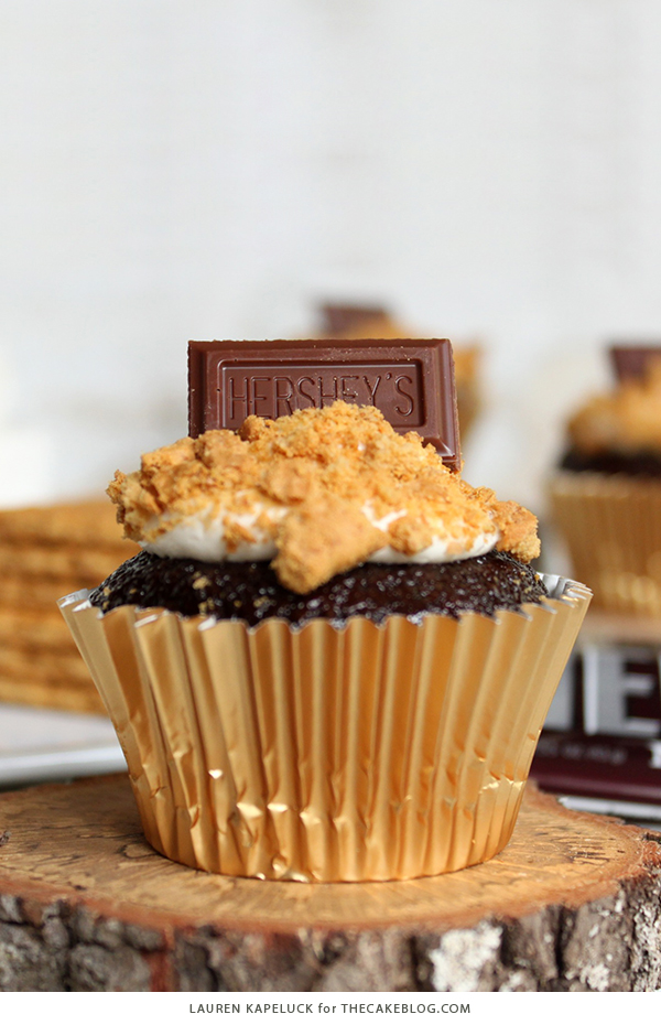 S'mores Cupcakes - easy s'more inspired cupcake recipe with chocolate cupcakes, marshmallow frosting, graham cracker crumbs and a hunk of milk chocolate | by Lauren Kapeluck for TheCakeBlog.com