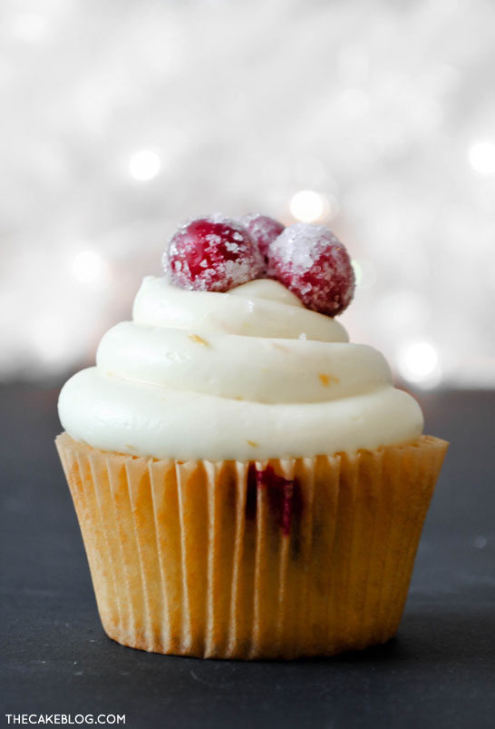 Cranberry Orange Cupcakes with sugared cranberries.  Perfect for the holidays and Christmas dessert | Carrie Sellman for TheCakeBlog.com