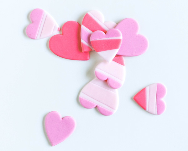 How to make striped heart toppers for cake and cupcakes | Tutorial by AK Cake Design for TheCakeBlog.com