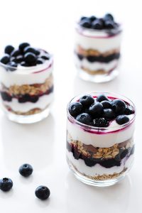 Blueberry Breakfast Parfaits with layers of roasted blueberries, granola and honey yogurt | by Carrie Sellman for TheCakeBlog.com