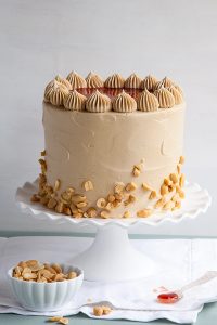 Peanut Butter & Jelly Cake | peanut butter cake with brown sugar peanut butter frosting, strawberry jam and chopped peanuts | by Tessa Huff for TheCakeBlog.com