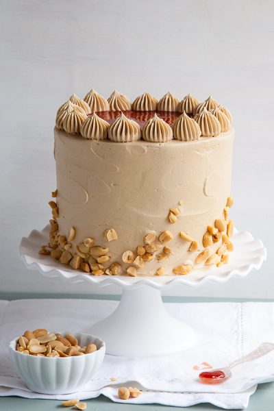 Peanut Butter & Jelly Cake | peanut butter cake with brown sugar peanut butter frosting, strawberry jam and chopped peanuts | by Tessa Huff for TheCakeBlog.com