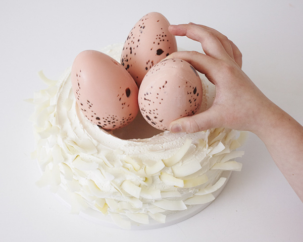 Easter Nest Cake - how to make a nest cake with roasted coconut and chocolate eggs for Easter dessert | by Cakegirls for TheCakeBlog.com