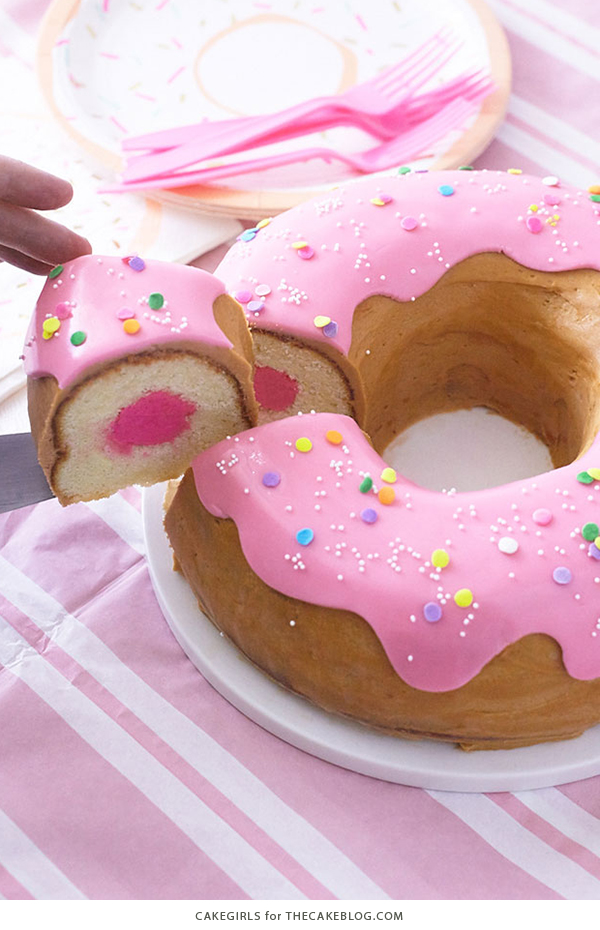 Giant Donut Cake! Learn how to make this adorable, sprinkle-coated, giant donut cake with a simple step-by-step tutorial | by Cakegirls for TheCakeBlog.com