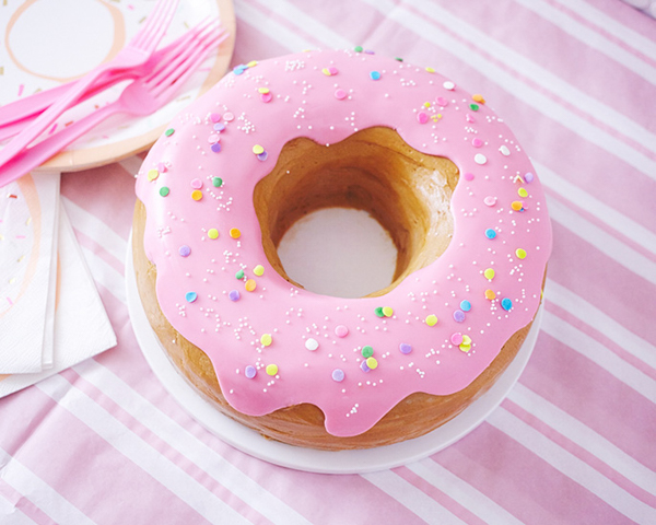 Giant Donut Cake! Learn how to make this adorable, sprinkle-coated, giant donut cake with a simple step-by-step tutorial | by Cakegirls for TheCakeBlog.com