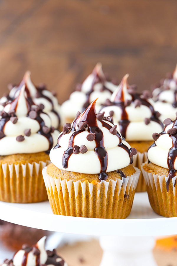 Pumpkin Chocolate Chip Cupcakes - pumpkin spice cupcakes studded with chocolate chips, topped with cream cheese frosting and chocolate sauce | by Lindsay Conchar for TheCakeBlog.com 