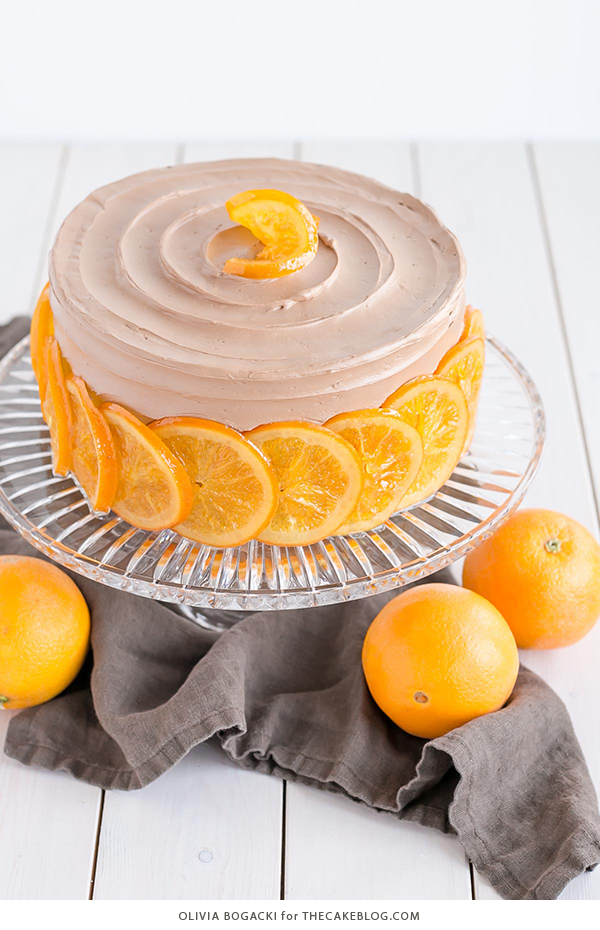 Chocolate Orange Cake - layer cake infused with orange zest and orange syrup, topped with chocolate frosting and candied orange slices | By Olivia Bogacki for TheCakeBlog.com