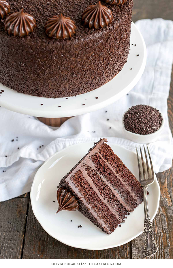 Chocolate Truffle Cake - a chocolate layer cake recipe with dense, moist chocolate cake, silky chocolate truffle frosting and chocolate flakes | by Olivia Bogacki for TheCakeBlog.com