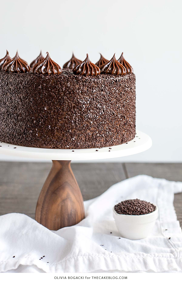 Chocolate Truffle Cake - a chocolate layer cake recipe with dense, moist chocolate cake, silky chocolate truffle frosting and chocolate flakes | by Olivia Bogacki for TheCakeBlog.com