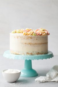 Coconut Cake - homemade coconut cake with creamy coconut milk, brushed with coconut syrup to keep it extra moist, and topped with vanilla bean buttercream frosting | by Tessa Huff for TheCakeBlog.com