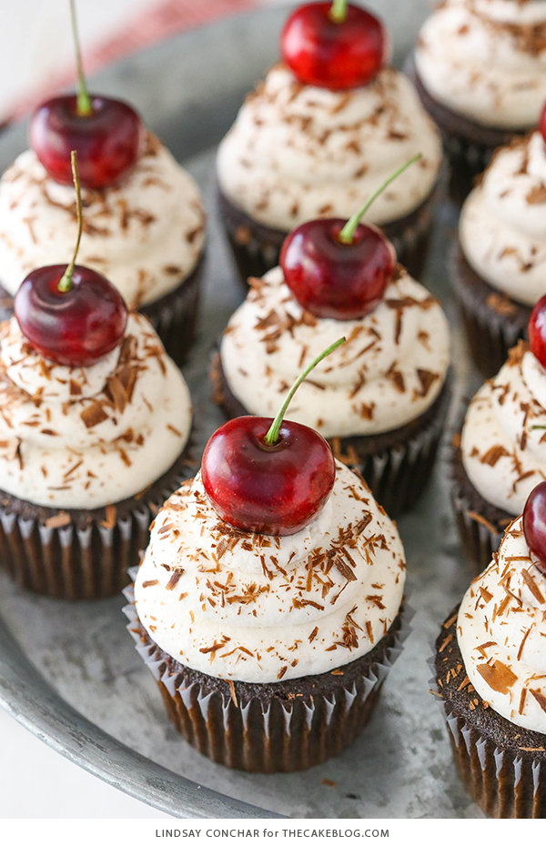 Black Forest Cupcakes - moist chocolate cupcake, homemade cherry filling and fresh vanilla whipped cream on top | by Lindsay Conchar for TheCakeBlog.com