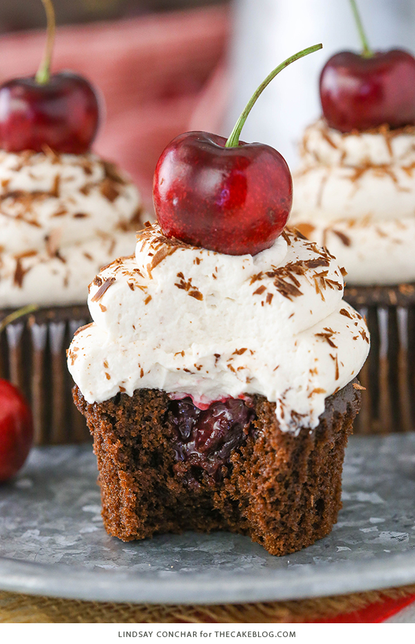 Black Forest Cupcakes - moist chocolate cupcake, homemade cherry filling and fresh vanilla whipped cream on top | by Lindsay Conchar for TheCakeBlog.com