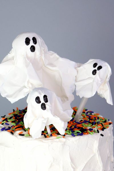 Chocolate Lollipop Ghosts - how to make edible lollipop ghosts for Halloween cakes and cupcakes using white chocolate and suckers | by Erin Gardner for TheCakeBlog.com