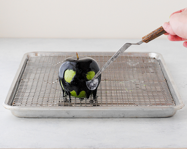 Poison Apple Cake - a black mirror glaze cake with an edible "poison apple" for Halloween | by Carrie Sellman for TheCakeBlog.com